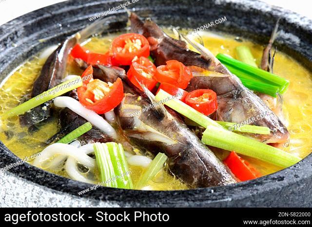 Chinese Food: Boiled small fish with pepper in a stone pot