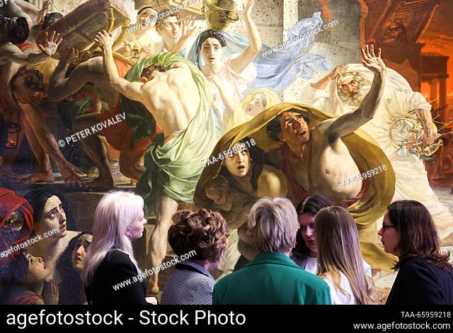 RUSSIA, ST PETERSBURG - DECEMBER 21, 2023: People stand by Karl Bryullov's history painting The Last Day of Pompeii at a press briefing on the start of the...