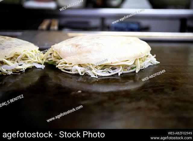 Japan, Kyoto, Okonomiyaki in restaurant kitchen