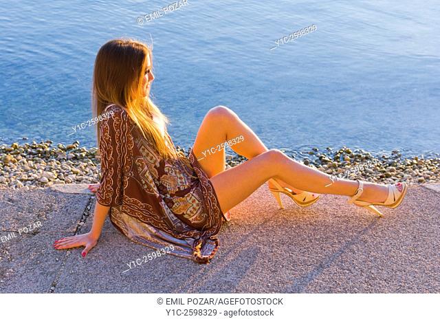 Young woman enjoy sunset warm light with legs exposed