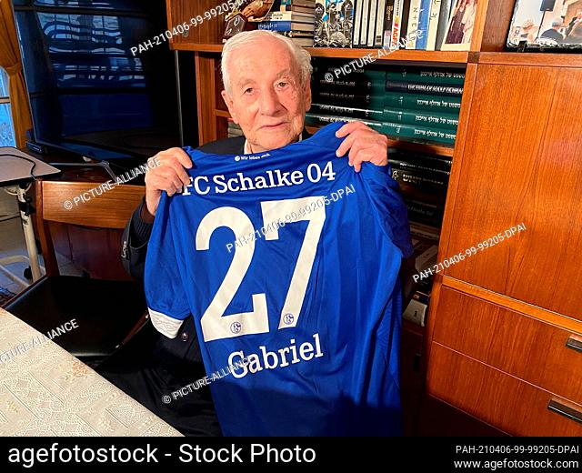 31 March 2021, Israel, Jerusalem: Gabriel Bach, then chief prosecutor of the Eichmann trials, holds up a fan shirt with his first name on it