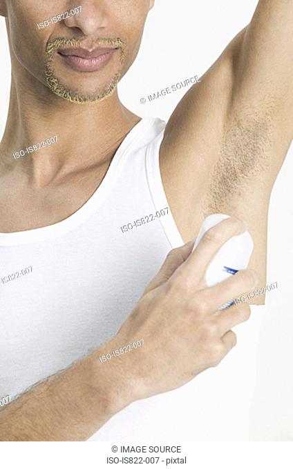 Man applying deodorant