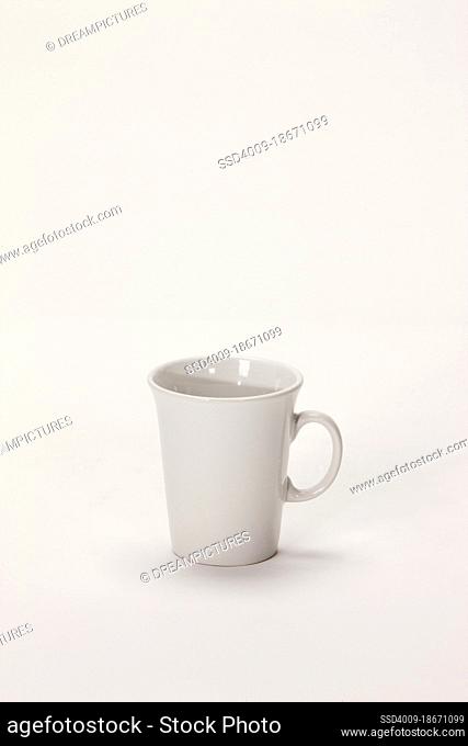 Still life of a white coffee mug on white background