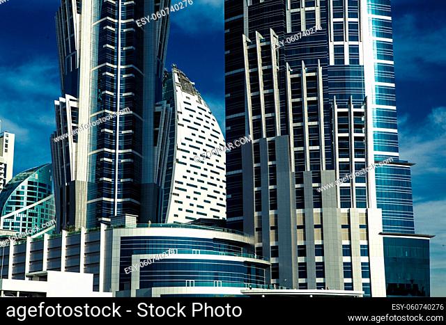 high luxury building skyscraper, blue and white facade with balcony