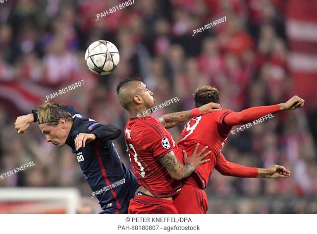 Munich's Arturo Vidal (C) and Kingsley Coman in action against Madrid's Fernando Torres during the UEFA Champions League semi final second leg soccer match...