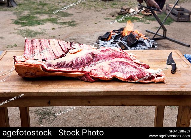 Asado course - half of beef prepared for grilling