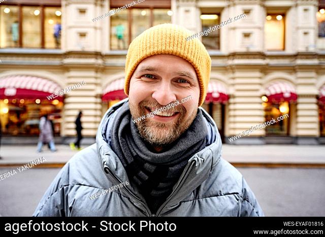 Bearded man wearing warm clothing in city