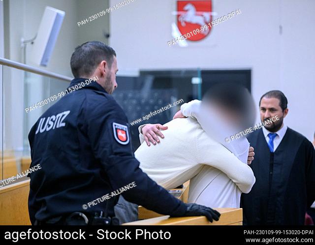 09 January 2023, Lower Saxony, Hanover: The two accused brothers hug each other before the start of the trial in the courtroom of the Hanover Regional Court