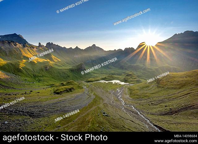 vals, mühlbach, bolzano province, south tyrol, italy. sunrise in the pfannealm basin. left the grave tip, right the worm mouth tip