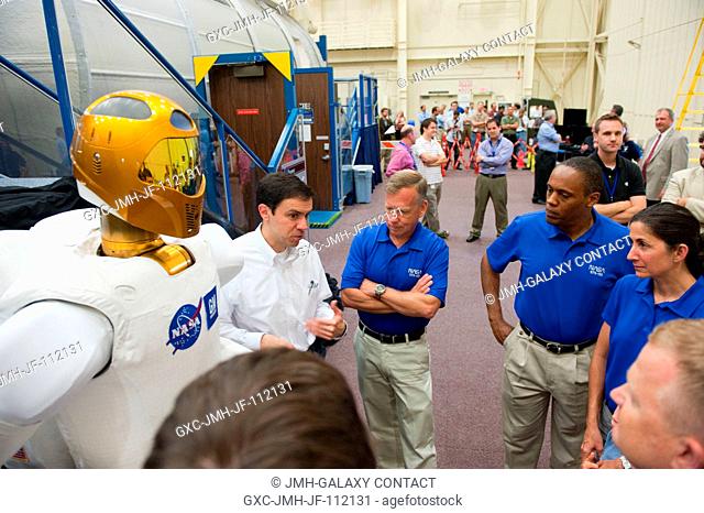 NASA Robonaut Project Manager Ron Diftler (left) explains some of Robonaut 2's features to members of the STS-133 crew -- continuing left, Steve Lindsey