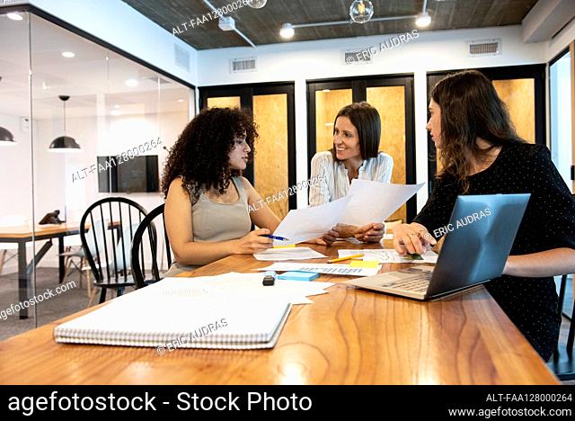 Businesswomen working together in board room