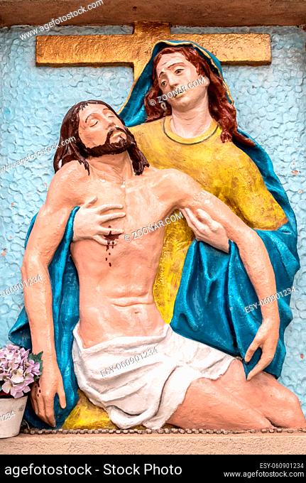 Bas-relief to colors representing The Pity of Michelangelo. Holy Mary mother and Jesus Christ after the Crucifixion. It can be used for concepts and events