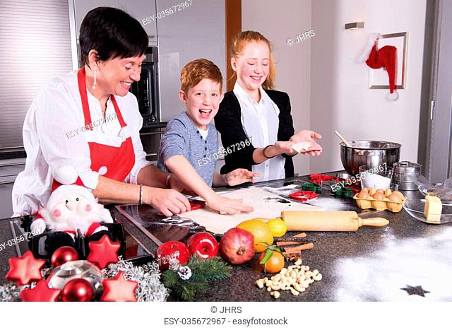 happy family in the kitchen preparing christmas bakery