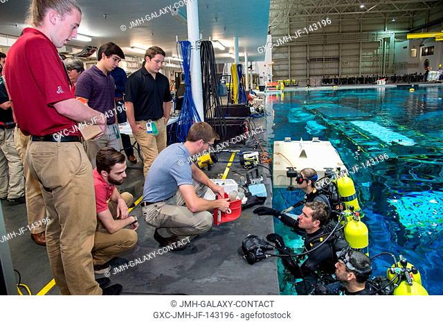 University students test spacewalk tool prototypes at Johnson Space Center's Neutral Buoyancy Laboratory. The tools were designed with a mission to an asteroid...