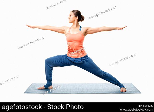 Beautiful sporty fit yogini woman practices yoga asana Virabhadrasana 2, warrior pose 2 isolated on white