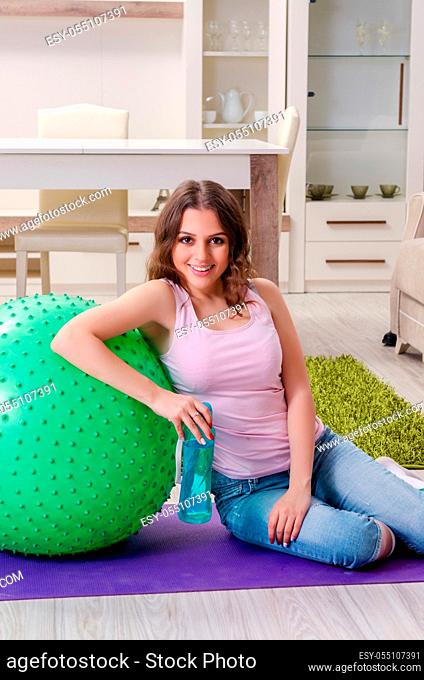 Young beautiful woman doing exercises at home