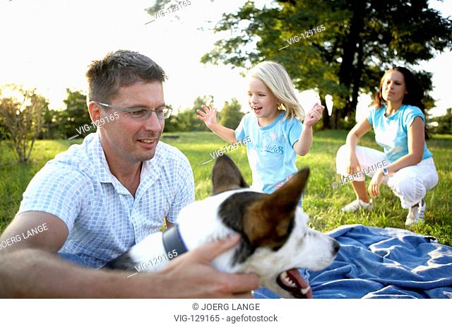 A young family seeking relaxation in a park.  - Dresden, GERMANY, 05/09/2005