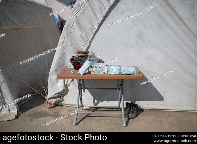 PRODUCTION - 18 February 2023, Turkey, Kahramanmaras: Surgical masks lie on a table in front of a tent in a makeshift camp for people who lost their homes in...
