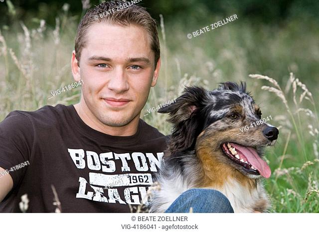 Young man with dog - , Schleswig-Holstein, Germany, 05/07/2007