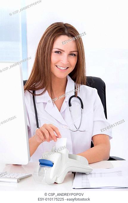 Doctor Inserting Credit Card Into Scanner