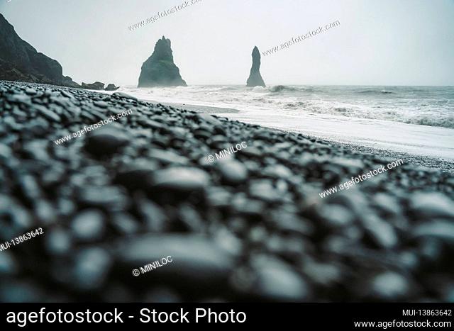 Stones on a black beach on moody day in Iceland