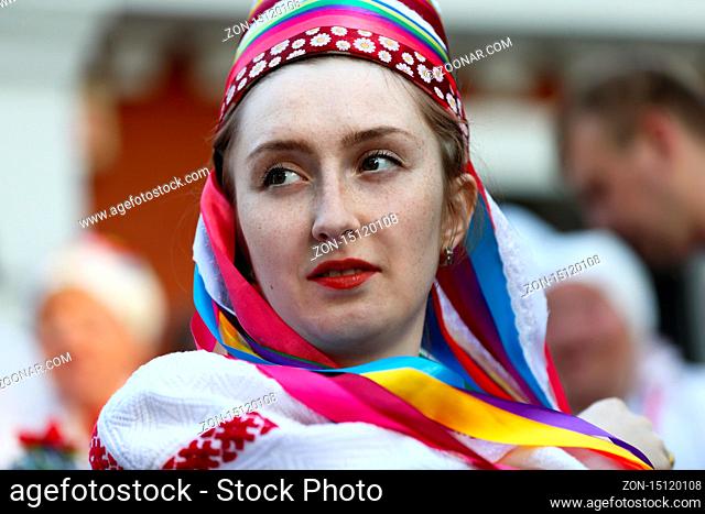 Wedding ceremony woman tied a headscarf on her head.Ethnic Slavic bride. Authentic wedding