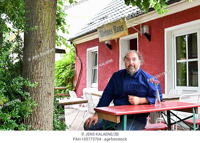 13.06.2018, Linum, Brandenburg: The cook and owner Frank Buthmann (45) sits in front of his restaurant ""Kleines Haus"". He has dedicated himself to regional...