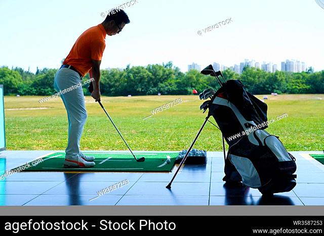 Young men playing golf
