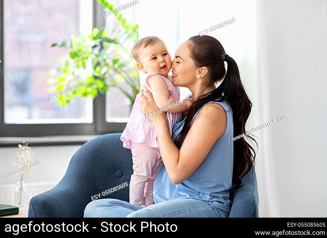 happy mother with little baby daughter at home