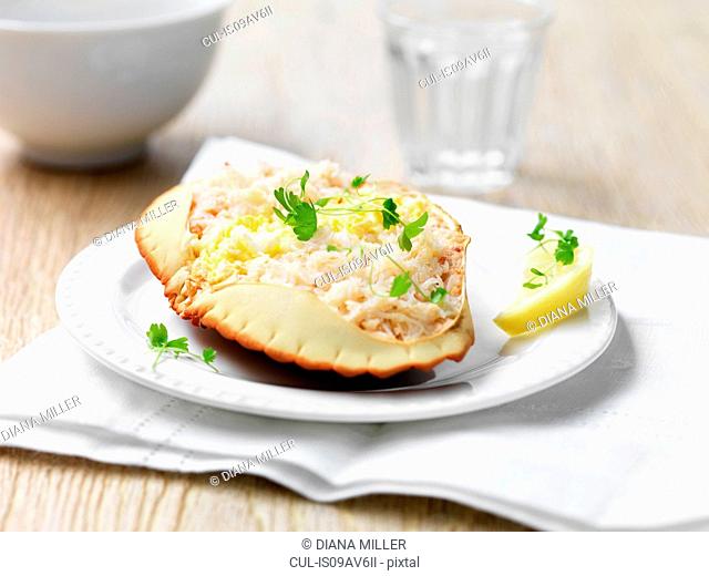 Orkney crab in shell with herbs and lemon wedge