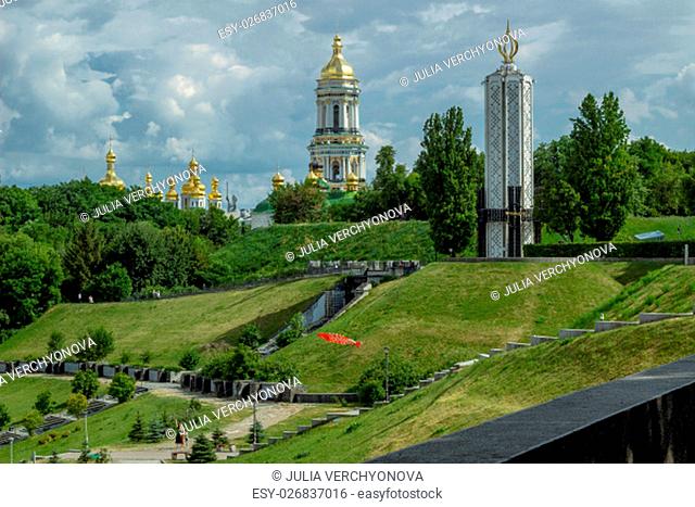 Glory park in Kiev on green hills with famine memorial and orthodox monastery