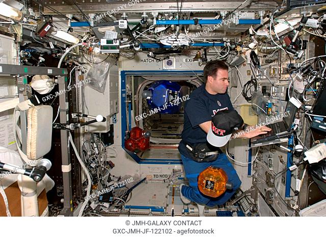 Astronaut Greg Chamitoff, Expedition 17 flight engineer, uses a computer while doing a check of the Synchronized Position Hold, Engage, Reorient