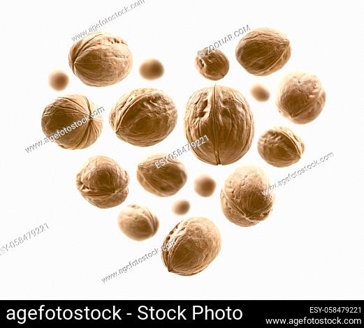 Whole walnuts in the shape of a heart on a white background