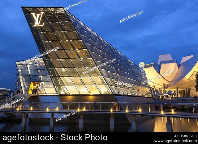 A view of the Louis Vuitton Island Maison in Singapore, the building is lit up at night time