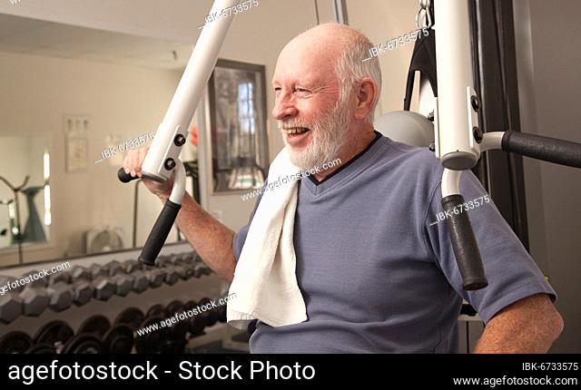 Senior adult man working out in the gym
