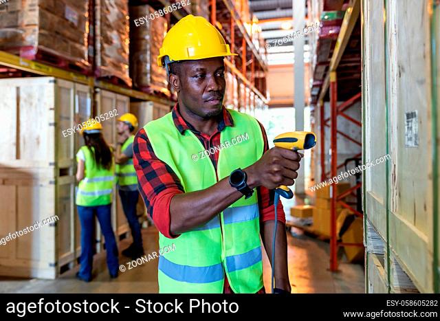 Portrait of african black warehouse worker hold hand scanner to do inventory work stock in distribution warehouse. Traceability FIFO LIFO inventory just in time...