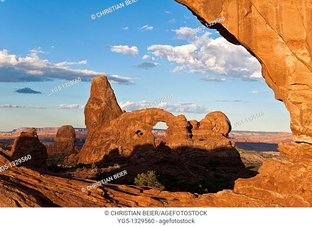 Looking through the NORTH WINDOW rock arch on the TURRET ARCH rock formation in the morning, Arches National Park, Utah, USA