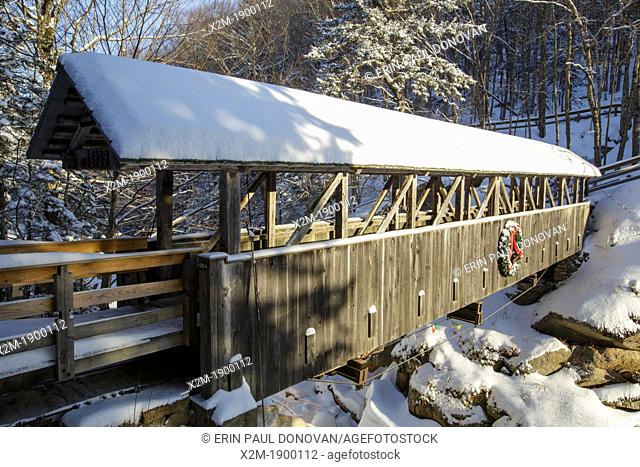 Franconia Notch State Park - Sentinel Pine Covered Bridge during the winter months  It is a footbridge which crosses over the Pemigewasset River in Lincoln