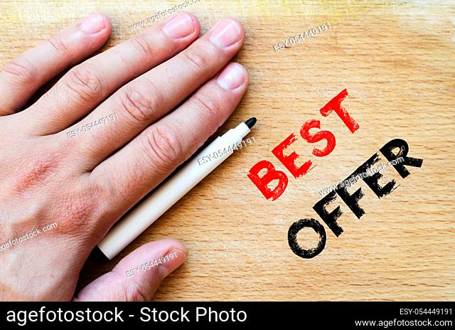Human hand over wooden background and best offer text concept