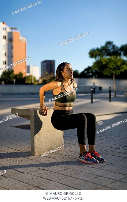 Young woman doing workout exercise in the city