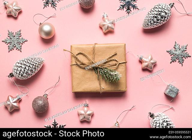 Christmas greeting card. Gift boxes and Christmas decorations layout on pink background, top view. Flat lay. Christmas and Holidays greeting card