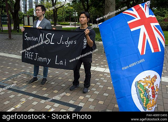 Pro-democracy activists for Hong Kong demonstrate in front of the building where Former British Prime Minister Liz Truss hold a press conference during her...
