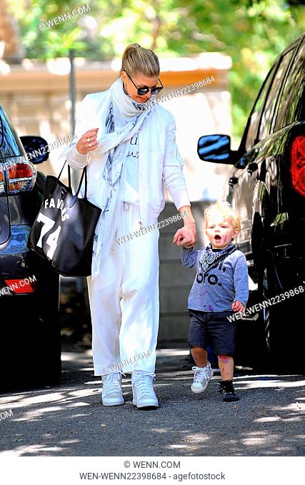 Fergie takes her son Axl Duhamel to a park in Brentwood, wearing all white and carrying a Givenchy 'Favelas 74' tote Featuring: Fergie