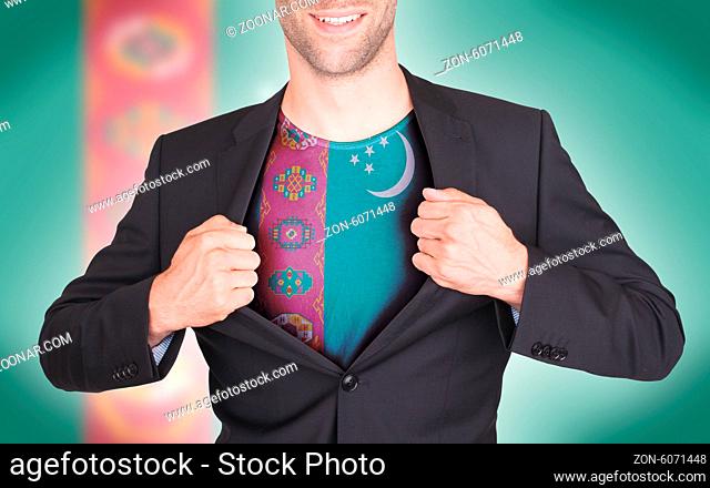 Businessman opening suit to reveal shirt with flag, Turkmenistan