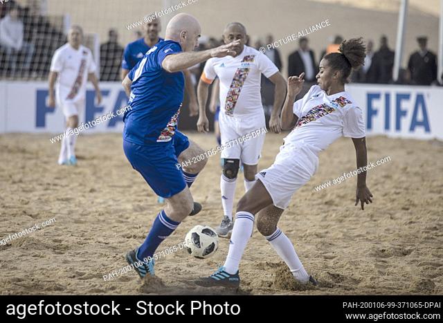 06 January 2020, Egypt, Gizeh: Gianni Infantino (l), President of FIFA, competes for the ball in a friendly match with Laura Georges