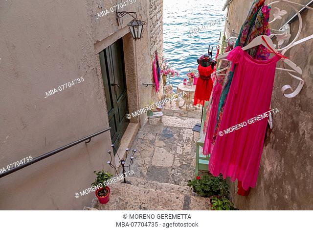 Glimpse towards the sea along the streets of Rovinj, a women's clothing store, Rovinj, Istria, Croatia