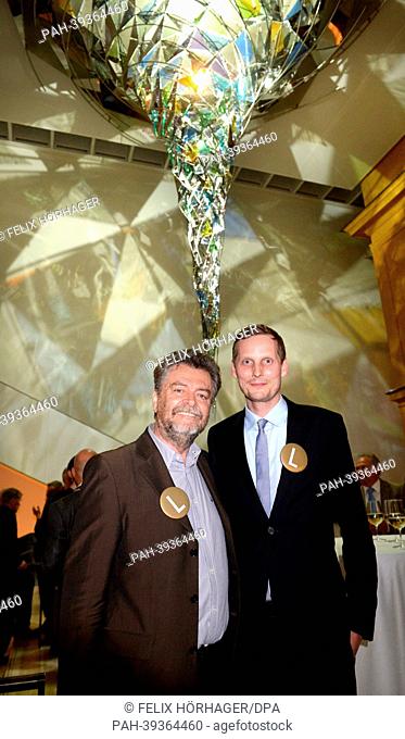 Museum director Helmut Friedel (L) and director of contemporay art Matthias Muehling stand in front of the work 'Wirbelwerk' by Olafur Eliasson at the new...