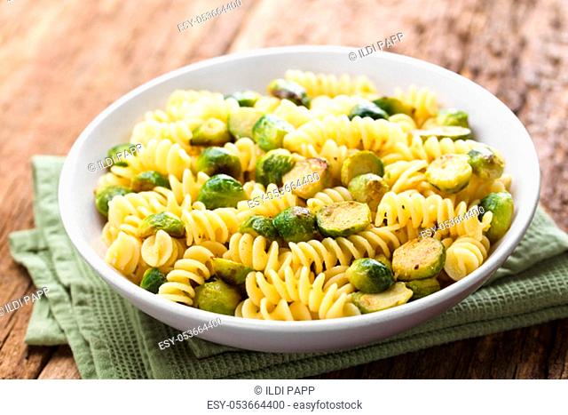 Fresh homemade pasta carbonara with roasted Brussels sprouts in bowl (Selective Focus, Focus one third into the dish)