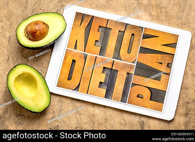 keto diet plan, high fat ketogenic diet concept - word abstract in vintage letterpress wood type on a digital tablet with cut avocado