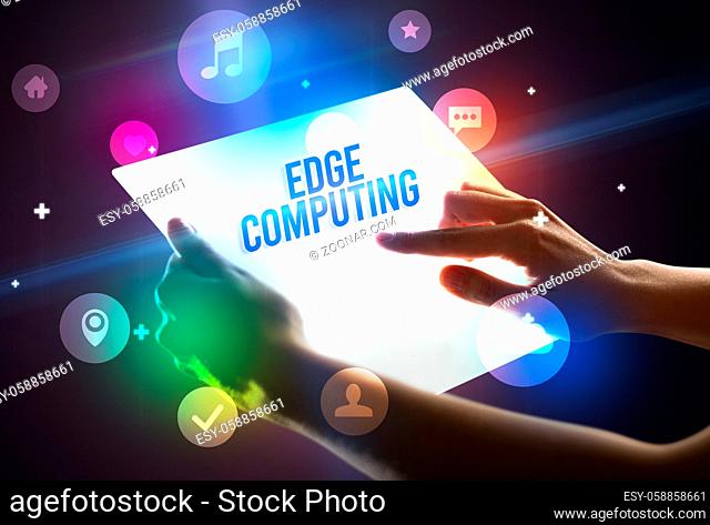 Holding futuristic tablet with EDGE COMPUTING inscription, new technology concept